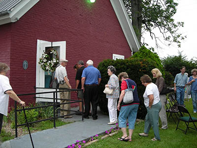 People filing in Old Cane Spring Church for the meeting